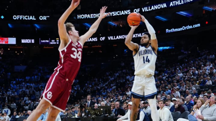 Dec 3, 2022; Philadelphia, Pennsylvania, USA; Villanova Wildcats guard Caleb Daniels (14) shoots a three point jump shot against Oklahoma Sooners forward Jacob Groves (34) during the second half at Wells Fargo Center. Mandatory Credit: Gregory Fisher-USA TODAY Sports