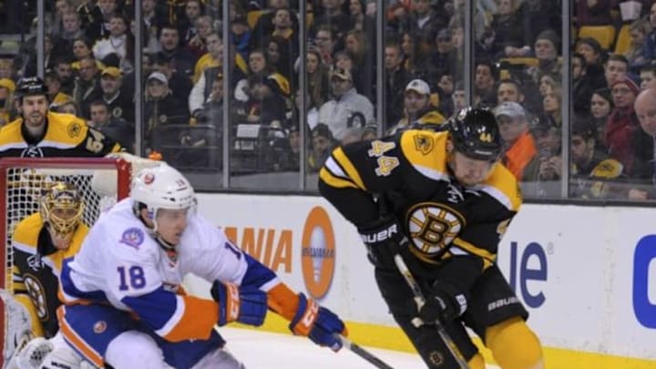 Feb 7, 2015; Boston, MA, USA; New York Islanders center Ryan Strome (18) tries to poke the puck away from Boston Bruins defenseman Dennis Seidenberg (44) during the third period at TD Banknorth Garden. Mandatory Credit: Bob DeChiara-USA TODAY Sports