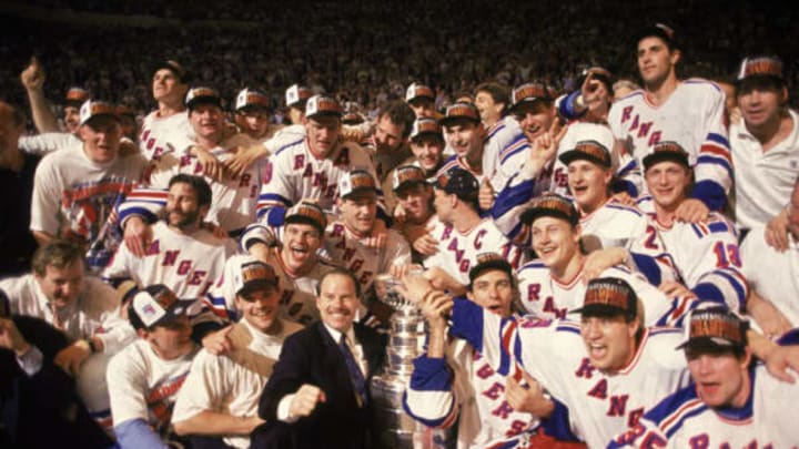 Group portrait of the New York Ranger hockey team on the ice as they pose with the Stanley Cup, following their series-winning defeat of the Vancouver Canucks in game 7 of the finals at Madison Square Garden, New York, New York, June 14, 1994. (Photo by Bruce Bennett Studios/Getty Images)