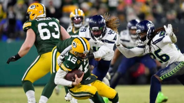 GREEN BAY, WISCONSIN – JANUARY 12: Shaquem Griffin #49 and Shaquill Griffin #26 of the Seattle Seahawks sack Aaron Rodgers #12 of the Green Bay Packers in the second half of the NFC Divisional Playoff game at Lambeau Field on January 12, 2020 in Green Bay, Wisconsin. (Photo by Quinn Harris/Getty Images)