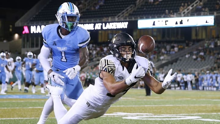 NEW ORLEANS, LA - AUGUST 30: Sage Surratt #14 of the Wake Forest Demon Deacons attempts to catch the ball as Donnie Lewis Jr. #1 of the Tulane Green Wave defends during the second half on August 30, 2018 in New Orleans, Louisiana. (Photo by Jonathan Bachman/Getty Images)
