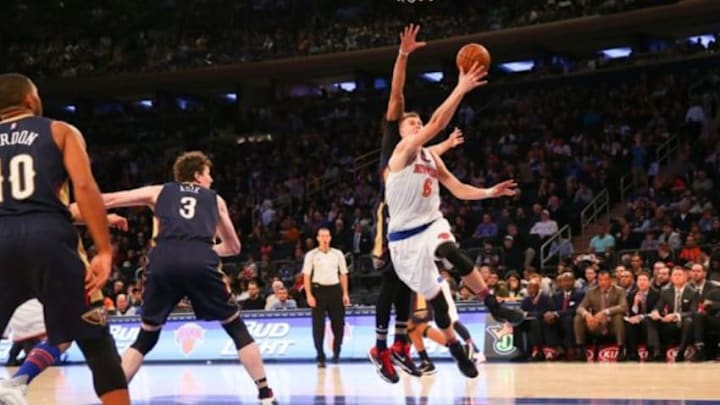 Nov 15, 2015; New York, NY, USA; New York Knicks forward Kristaps Porzingis (6) reaches for the net during the third quarter against the New Orleans Pelicans at Madison Square Garden. New York Knicks won 95-87. Mandatory Credit: Anthony Gruppuso-USA TODAY Sports