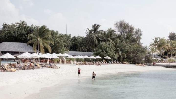 MALE, MALDIVES - FEBRUARY 01: A couple taking photos on the beach in the afternoon during their honeymoon on February 01, 2016 at Centara Ras fushi Resort and Spa, Maldives. China's top diplomats estimates around half a million Chinese tourists this year as the Maldives aim to lure 1.5 million Chinese annually by 2018. The tropical islands remain as one of the most popular holiday destination for Chinese travellers after Thailand's Phuket and South Korea's Jeju island. The number of Chinese tourists continue to climb over the past few years with an increasing number of guest houses popping up on the islands and high end resorts attract holiday seekers with short luxury package deals. (Photo by Giulio Di Sturco/Getty Images)