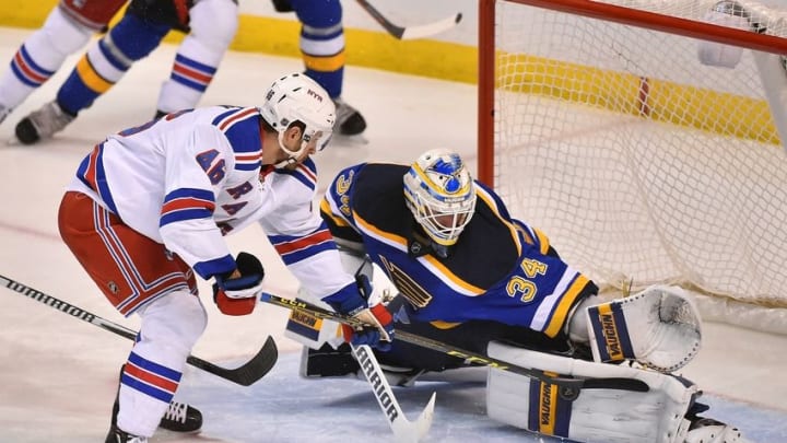 Feb 25, 2016; St. Louis, MO, USA; St. Louis Blues goalie Jake Allen (34) blocks the shot of New York Rangers left wing Marek Hrivik (46) during the third period at Scottrade Center. The New York Rangers defeat the St. Louis Blues 2-1. Mandatory Credit: Jasen Vinlove-USA TODAY Sports