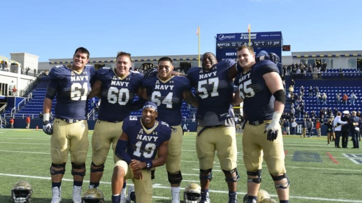 Oct 31, 2015; Annapolis, MD, USA; Navy Midshipmen quarterback Keenan Reynolds (19) poses for a photo with his offensive line after the game against the South Florida Bulls at Navy Marine Corps Memorial Stadium. Navy Midshipmen defeated South Florida Bulls 29-17. Mandatory Credit: Tommy Gilligan-USA TODAY Sports