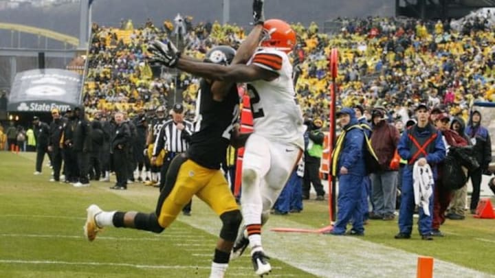 Dec 29, 2013; Pittsburgh, PA, USA; Cleveland Browns wide receiver Josh Gordon (right) reaches for a pass in the endzone as Pittsburgh Steelers cornerback Ike Taylor (left) defends during the fourth quarter at Heinz Field. The Pittsburgh Steelers won 20-7. Mandatory Credit: Charles LeClaire-USA TODAY Sports