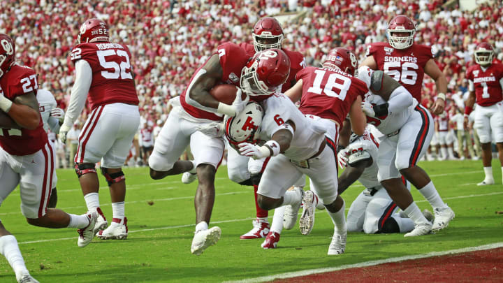 NORMAN, OK – SEPTEMBER 28: Running back Trey Sermon #4 of the Oklahoma Sooners hits linebacker Riko Jeffers #6 of the Texas Tech Red Raiders on his way to a touchdown at Gaylord Family Oklahoma Memorial Stadium on September 28, 2019 in Norman, Oklahoma. (Photo by Brett Deering/Getty Images)