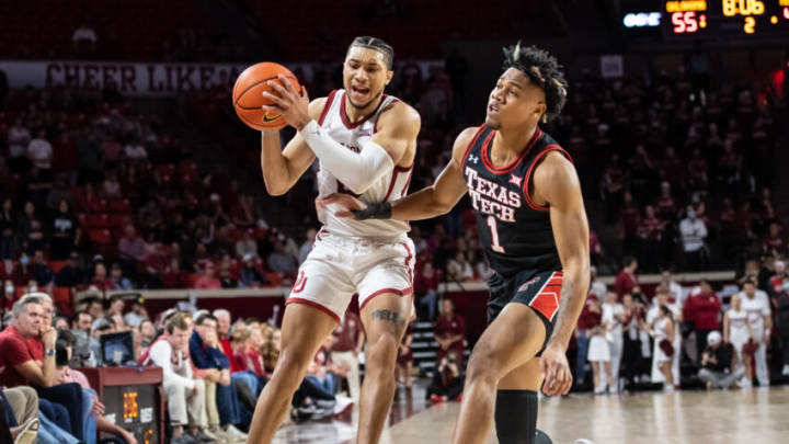 Feb 9, 2022; Norman, Oklahoma, USA; Oklahoma Sooners guard Jordan Goldwire (0) fouled by Texas Tech Red Raiders guard Terrence Shannon Jr. (1) during the second half at Lloyd Noble Center. Mandatory Credit: Rob Ferguson-USA TODAY Sports