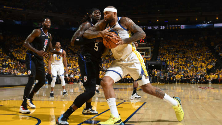 OAKLAND, CA – APRIL 13: DeMarcus Cousins #0 of the Golden State Warriors drives past Montrezl Harrell #5 of the LA Clippers during Game One of Round One of the 2019 NBA Playoffs on April 13, 2019 at ORACLE Arena in Oakland, California. (Photo by Noah Graham/NBAE via Getty Images)