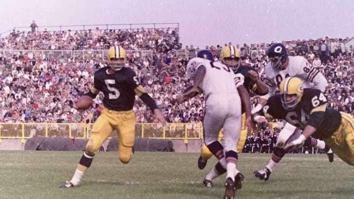 Green Bay Packers running back Paul Hornung (5) runs the sweep as guard Jerry Kramer (64) attempts to block Chicago Bears defensive back Dave Whitsell (23). The Packers defeated the Bears 49-0 on Sept. 30, 1962 at New City Stadium, later renamed Lambeau Field, in Green Bay, Wis.Gpg Historical Packers Vs Bears 08182022 0006