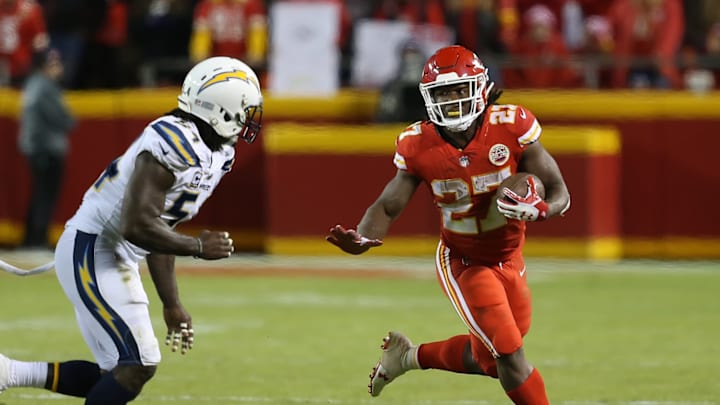 Kansas City Chiefs running back Kareem Hunt (27) looks to stiff arm Los Angeles Chargers outside linebacker Melvin Ingram (54) (Photo by Scott Winters/Icon Sportswire via Getty Images)