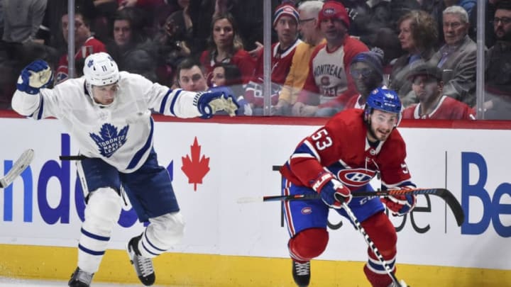 MONTREAL, QC - FEBRUARY 08: Victor Mete #53 of the Montreal Canadiens skates the puck against Zach Hyman #11 of the Toronto Maple Leafs during the second period at the Bell Centre on February 8, 2020 in Montreal, Canada. (Photo by Minas Panagiotakis/Getty Images)