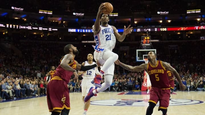 Nov 27, 2016; Philadelphia, PA, USA; Philadelphia 76ers center Joel Embiid (21) scores past Cleveland Cavaliers guard Kyrie Irving (2) and guard J.R. Smith (5) during the second half at Wells Fargo Center. Mandatory Credit: Bill Streicher-USA TODAY Sports