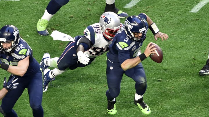 Russell Wilson #3 of the Seattle Seahawks runs with the ball while being pursued by Chandler Jones #95 of the New England Patriots during Super Bowl XLIX February 1, 2015.  (Photo by Focus on Sport/Getty Images)