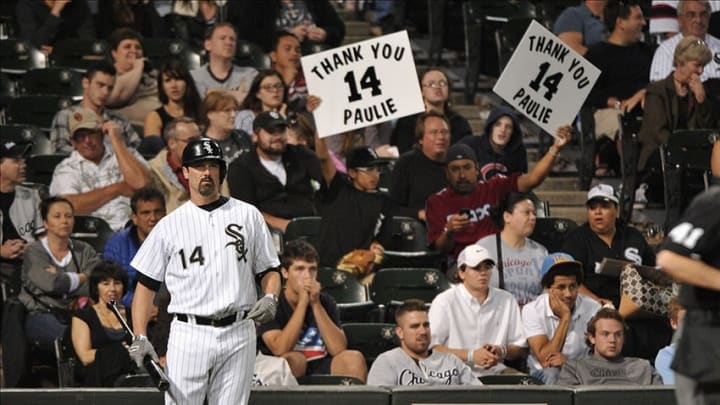 Sep 27, 2013; Chicago, IL, USA; Fans hold up signs as Chicago White Sox first baseman Paul Konerko (14) gets ready in the batters box against the Kansas City Royals during the ninth inning at U.S Cellular Field. The Royals beat the Chicago White Sox 6-1. Mandatory Credit: Rob Grabowski-USA TODAY Sports