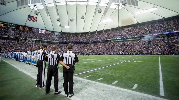 Dec 29, 2013; Minneapolis, MN, USA; Referees, players and fans stand for the national anthem before the game with the Detroit Lions and the Minnesota Vikings at the last game at Mall of America Field at H.H.H. Metrodome. The Vikings win 14-13. Mandatory Credit: Bruce Kluckhohn-USA TODAY Sports