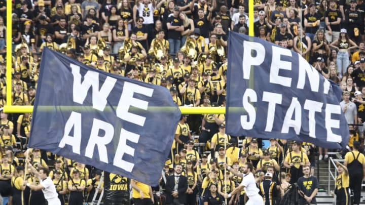 IOWA CITY, IOWA- OCTOBER 9: Cheerleaders carry flags to celebrate a field goal by Penn State Nittany Lions during the second half against the Iowa Hawkeyes at Kinnick Stadium on October 9, 2021 in Iowa City, Iowa. (Photo by Matthew Holst/Getty Images)