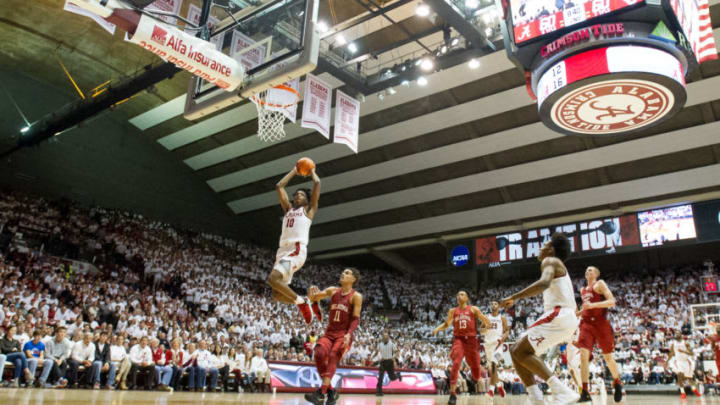 TUSCALOOSA, AL - JANUARY 27: Herbert Jones #10 of the Alabama Crimson Tide dunks the ball in front of Christian James #0 of the Oklahoma Sooners during the game at Coleman Coliseum on January 27, 2018 in Tuscaloosa, Alabama. (Photo by Michael Chang/Getty Images)