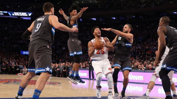 Dec 22, 2016; New York, NY, USA; New York Knicks point guard Derrick Rose (25) drives against Orlando Magic center Nikola Vucevic (9) and Orlando Magic point guard Elfrid Payton (4) and Orlando Magic shooting guard Evan Fournier (10) during the third quarter at Madison Square Garden. Mandatory Credit: Brad Penner-USA TODAY Sports