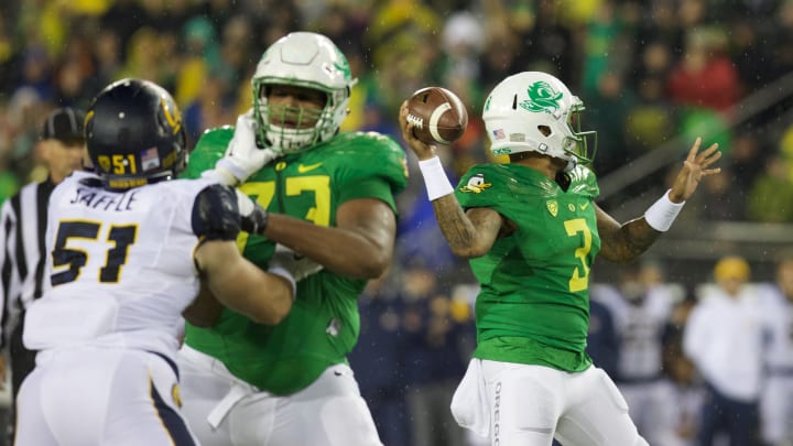 Nov 7, 2015; Eugene, OR, USA; Oregon Ducks offensive lineman Tyrell Crosby (73) blocks California Golden Bears defensive end Cameron Saffle (51) as Oregon Ducks quarterback Vernon Adams Jr. (3) throws an interception in the first quarter at Autzen Stadium. Mandatory Credit: Scott Olmos-USA TODAY Sports