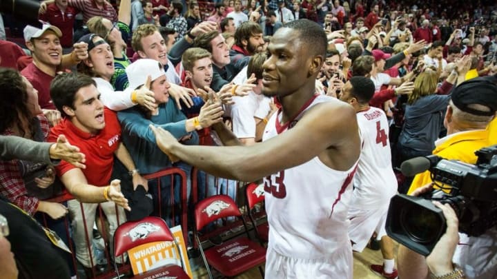 Jan 27, 2016; Fayetteville, AR, USA; Arkansas Razorbacks forward Moses Kingsley (33) shakes hands with fans in the student section after defeating the Texas A&M Aggies at Bud Walton Arena. The Razorbacks won 74-71. Mandatory Credit: Gunnar Rathbun-USA TODAY Sports