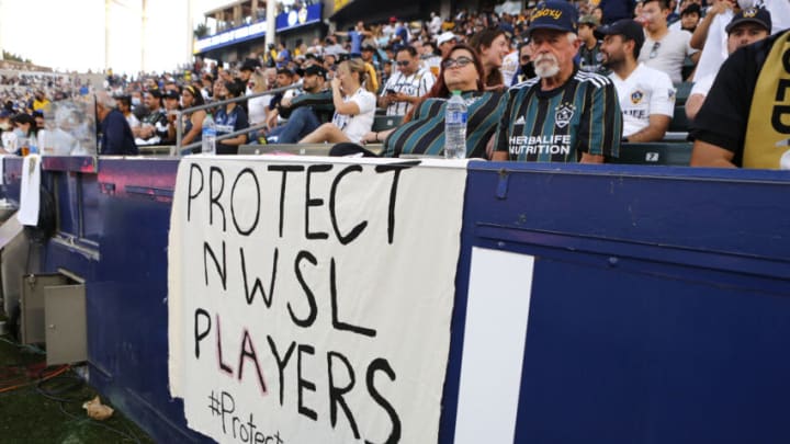 Sign supporting NWSL players during game between LA Galaxy and LAFC (Photo by Katharine Lotze/Getty Images)