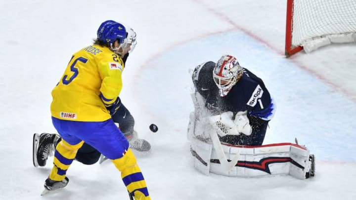 Sweden's Jacob de la Rose (L) and US's Keith Kinkaid vie for the puck during the semifinal match Sweden vs USA of the 2018 IIHF Ice Hockey World Championship at the Royal Arena in Copenhagen, Denmark, on May 19, 2018. (Photo by JOE KLAMAR / AFP) (Photo credit should read JOE KLAMAR/AFP/Getty Images)