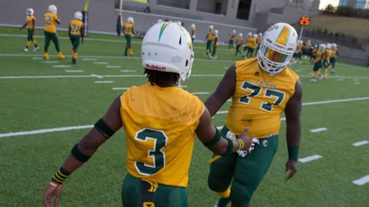 Carver's Juwon Gaston (3) and Carver's James Robinson (77) shake hands during warm ups at Cramton Bowl in Montgomery, Ala., on Thursday, Sept. 26, 2019. Lee leads Carver 28-7 at halftime.Jc Fbcarverlee25
