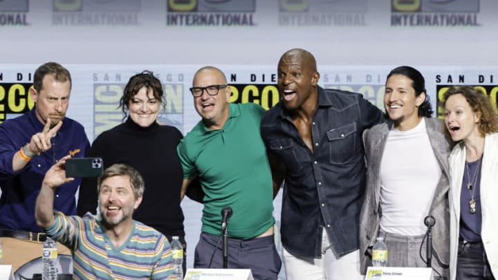 SAN DIEGO, CALIFORNIA - JULY 22: (L-R) Scott M. Gimple, Chris Hardwick, Channing Powell, Michael E. Satrazemis, Terry Crews, Danny Ramirez, and Samantha Morton pose for a selfie photo onstage at AMC's "Tales of the Walking Dead" panel during 2022 Comic-Con International: San Diego at San Diego Convention Center on July 22, 2022 in San Diego, California. (Photo by Kevin Winter/Getty Images)