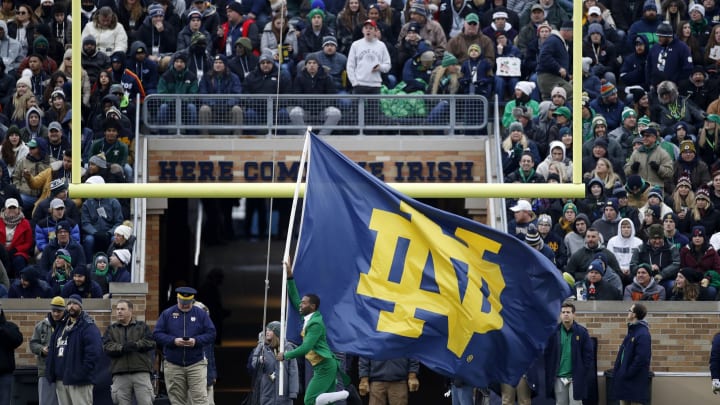SOUTH BEND, IN – NOVEMBER 23: Notre Dame Fighting Irish leprechaun mascot carries the school flag after a touchdown against the Boston College Eagles during a game at Notre Dame Stadium on November 23, 2019, in South Bend, Indiana. Notre Dame defeated Boston College 40-7. (Photo by Joe Robbins/Getty Images)
