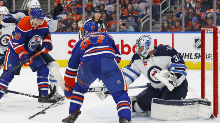 Oct 21, 2023; Edmonton, Alberta, CAN; Winnipeg Jets goaltender Connor Hellebuyck (37) makes a save on Edmonton Oilers forward Connor McDavid (97) during the first period at Rogers Place. Mandatory Credit: Perry Nelson-USA TODAY Sports