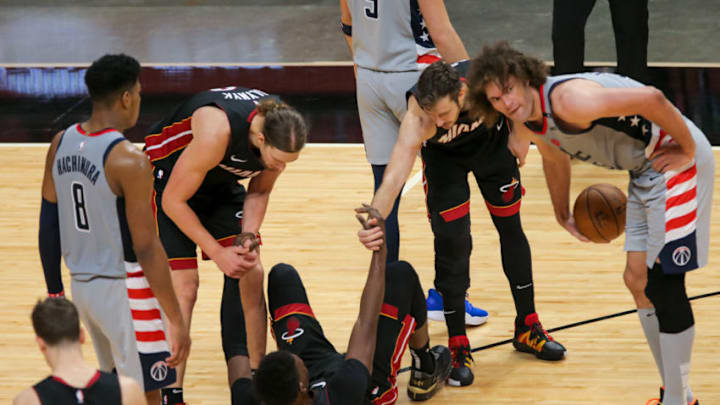 Miami Heat center Bam Adebayo (13) gets some help to get up from guard Goran Dragic (7) and forward Kelly Olynyk (9) during the third quarter (Sam Navarro-USA TODAY Sports)