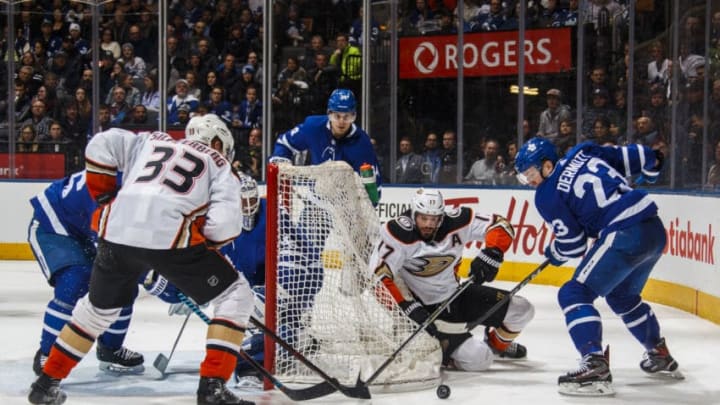 TORONTO, ON - FEBRUARY 05 - : Travis Dermott #23 of the Toronto Maple Leafs battles with Ryan Kesler #17 and Jakob Silfverberg #33 of the Anaheim Ducks during the second period at the Air Canada Centre on February 5, 2018 in Toronto, Ontario, Canada. (Photo by Mark Blinch/NHLI via Getty Images)