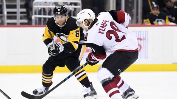 PITTSBURGH, PA - NOVEMBER 07: Arizona Coyotes Center Mario Kempe (29) tries to the skate the puck past Pittsburgh Penguins Defenseman Brian Dumoulin (8) during the first period in the NHL game between the Pittsburgh Penguins and the Arizona Coyotes on November 7, 2017, at PPG Paints Arena in Pittsburgh, PA. The Penguins defeated the Coyotes 3-1. (Photo by Jeanine Leech/Icon Sportswire via Getty Images)