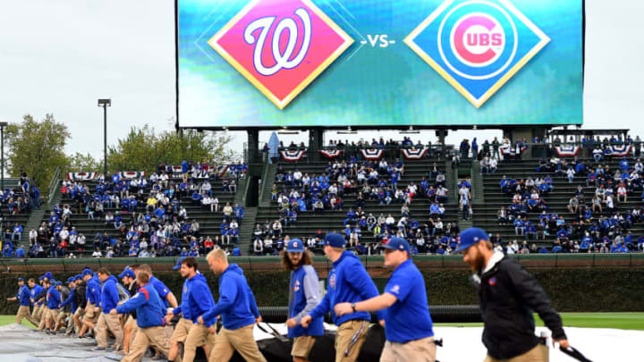 CHICAGO, IL - OCTOBER 10: Members of the grounds crew cover the infield with a tarp before game four of the National League Division Series between the Washington Nationals and the Chicago Cubs at Wrigley Field on October 10, 2017 in Chicago, Illinois. (Photo by Stacy Revere/Getty Images)