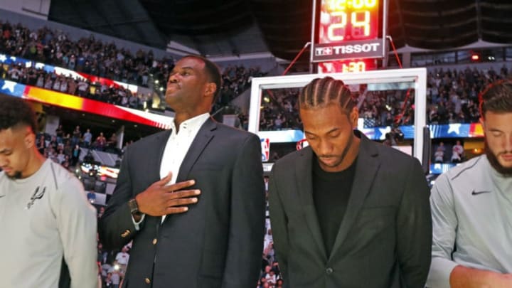 SAN ANTONIO,TX - OCTOBER 18: Former Spurs David Robinson joins injured Kawhi Leonard #2 of the San Antonio Spurs during the national anthem before the game against the Minnesota Timberwolves at AT&T Center on October 18, 2017 in San Antonio, Texas. NOTE TO USER: User expressly acknowledges and agrees that , by downloading and or using this photograph, User is consenting to the terms and conditions of the Getty Images License Agreement. (Photo by Ronald Cortes/Getty Images)