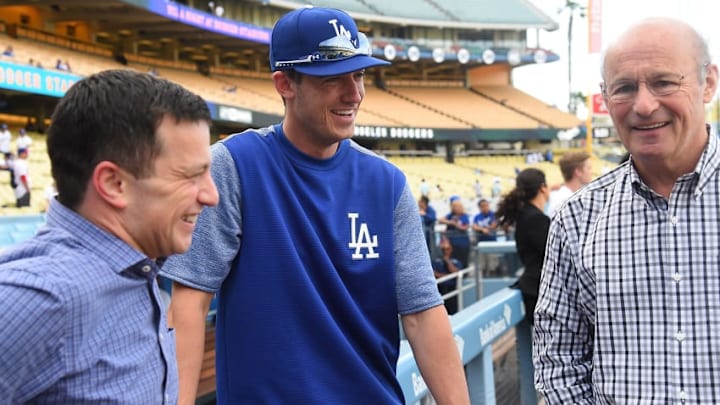 LOS ANGELES, CA - APRIL 28: Andrew Friedman, President of Baseball Operations, and Stan Kasten, President, and part-owner of the Los Angeles Dodgers talk with Cody Bellinger
