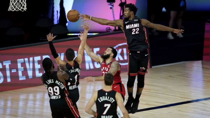 Fred VanVleet #23 of the Toronto Raptors shoots between Jimmy Butler #22 and Tyler Herro #14 of the Miami Heat in the second half (Photo by Ashley Landis-Pool/Getty Images)