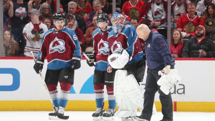 DENVER, CO - MARCH 30: Head athletic trainer Matthew Sokolowski of the Colorado Avalanche helps goaltender Semyon Varlamov