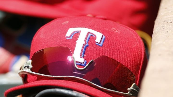 Aug 2, 2015; Arlington, TX, USA; A general view of a Texas Rangers hat and glasses in the dugout during the game against the San Francisco Giants at Globe Life Park in Arlington. Texas won 2-1. Mandatory Credit: Tim Heitman-USA TODAY Sports