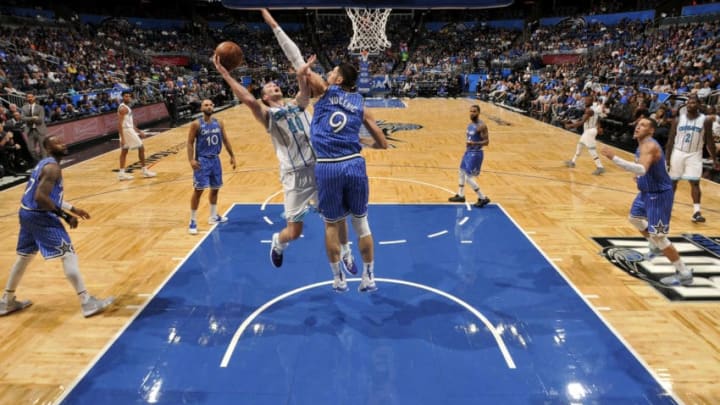 ORLANDO, FL - OCTOBER 19: Cody Zeller #40 of the Charlotte Hornets shoots the ball against Nikola Vucevic #9 of the Orlando Magic during a game on October 19, 2018 at Amway Center in Orlando, Florida. NOTE TO USER: User expressly acknowledges and agrees that, by downloading and/or using this Photograph, user is consenting to the terms and conditions of the Getty Images License Agreement. Mandatory Copyright Notice: Copyright 2018 NBAE (Photo by Fernando Medina/NBAE via Getty Images)