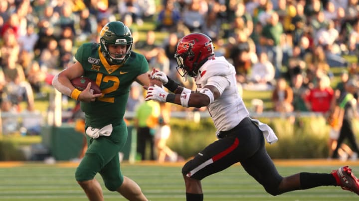 WACO, TEXAS - OCTOBER 12: Charlie Brewer #12 of the Baylor Bears is pursued by Adrian Frye #7 of the Texas Tech Red Raiders on October 12, 2019 in Waco, Texas. (Photo by Richard Rodriguez/Getty Images)