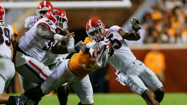 KNOXVILLE, TENNESSEE - OCTOBER 05: Brian Herrien #35 of the Georgia Bulldogs attempts to avoid a tackle from Daniel Bituli #35 of the Tennessee Volunteers during the third quarter of the game at Neyland Stadium on October 05, 2019 in Knoxville, Tennessee. (Photo by Silas Walker/Getty Images)