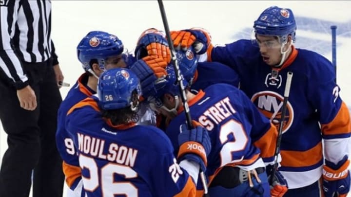 May 7, 2013; Uniondale, NY, USA; New York Islanders defenseman Mark Streit (2) celebrates his goal with teammates during the second period against the Pittsburgh Penguins in game four of the first round of the 2013 Stanley Cup playoffs at Nassau Veterans Memorial Coliseum. Mandatory Credit: Anthony Gruppuso-USA TODAY Sports