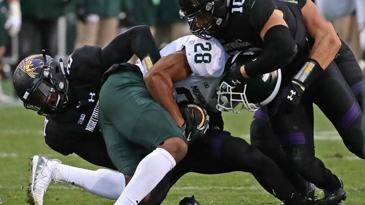 EVANSTON, IL – OCTOBER 28: Madre London #28 of the Michigan State Spartans is gang-tackled by (L-R) Kyle Queiro #21, Brett Walsh #10 and Paddy Fisher #42 of the Northwestern Wildcats at Ryan Field on October 28, 2017 in Evanston, Illinois. Northwestern defeated Michigan State 39-31 in triple overtime.(Photo by Jonathan Daniel/Getty Images)