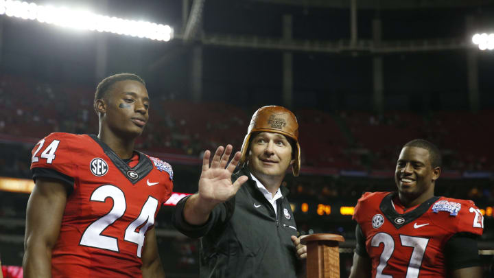 Sep 3, 2016; Atlanta, GA, USA; Georgia Bulldogs head coach Kirby Smart puts on the Old Leather Helmet after the 2016 Chick-Fil-A Kickoff game against the North Carolina Tar Heels at Georgia Dome. Georgia won 33-24. Mandatory Credit: Jason Getz-USA TODAY Sports