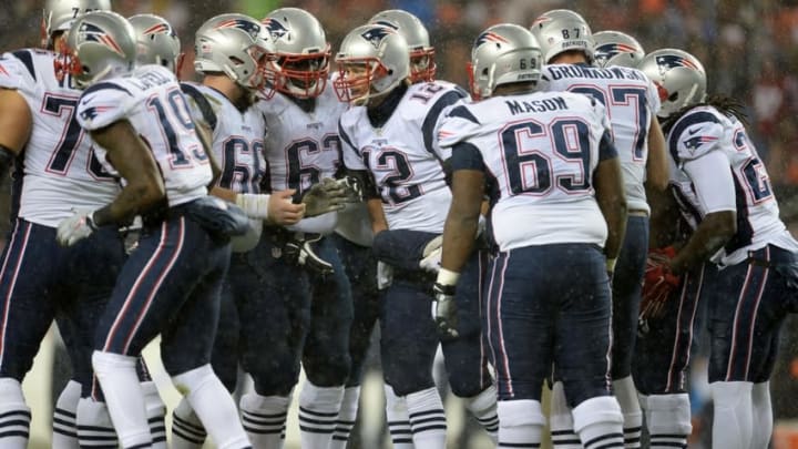 Nov 29, 2015; Denver, CO, USA; New England Patriots quarterback Tom Brady (12) huddles with his teammates in the second quarter against the Denver Broncos at Sports Authority Field at Mile High. Mandatory Credit: Ron Chenoy-USA TODAY Sports