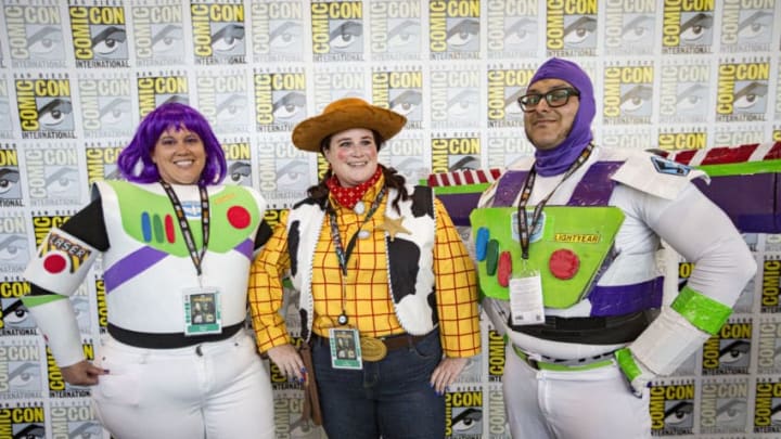 SAN DIEGO, CALIFORNIA – JULY 19: (L-R) Cosplayers Jessica Shaw as Buzz Lightyear, Tony Escobedo as Woody, and Salvador Solis as Buzz Lightyear from “Toy Story” pose at 2019 Comic-Con International on July 19, 2019 in San Diego, California. (Photo by Daniel Knighton/Getty Images)