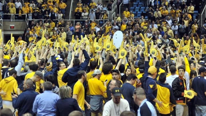 March 8, 2014; Morgantown, WV, USA; West Virginia Mountaineer fans on court after game agains the Kansas Jayhawks at WVU Coliseum. West Virginia wins 92-86.Mandatory Credit: Dan Friend-USA TODAY Sports