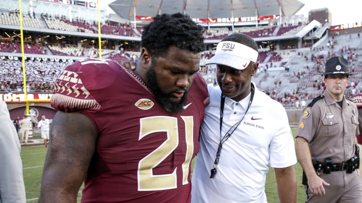 TALLAHASSEE, FL – SEPTEMBER 22: Head Coach Willie Taggart talks with Defensive Tackle Marvin Wilson #21 of the Florida State Seminoles after the game against the Northern Illinois Huskies at Doak Campbell Stadium on Bobby Bowden Field on September 22, 2018 in Tallahassee, Florida. The Seminoles defeated the Huskies 37 to 19. (Photo by Don Juan Moore/Getty Images)